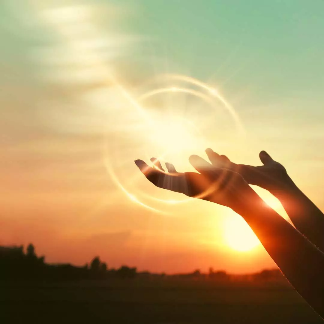 Emotional Release: Letting Go of Stress and Tension Hands releasing light symbolizing the emotional release and letting go of stress